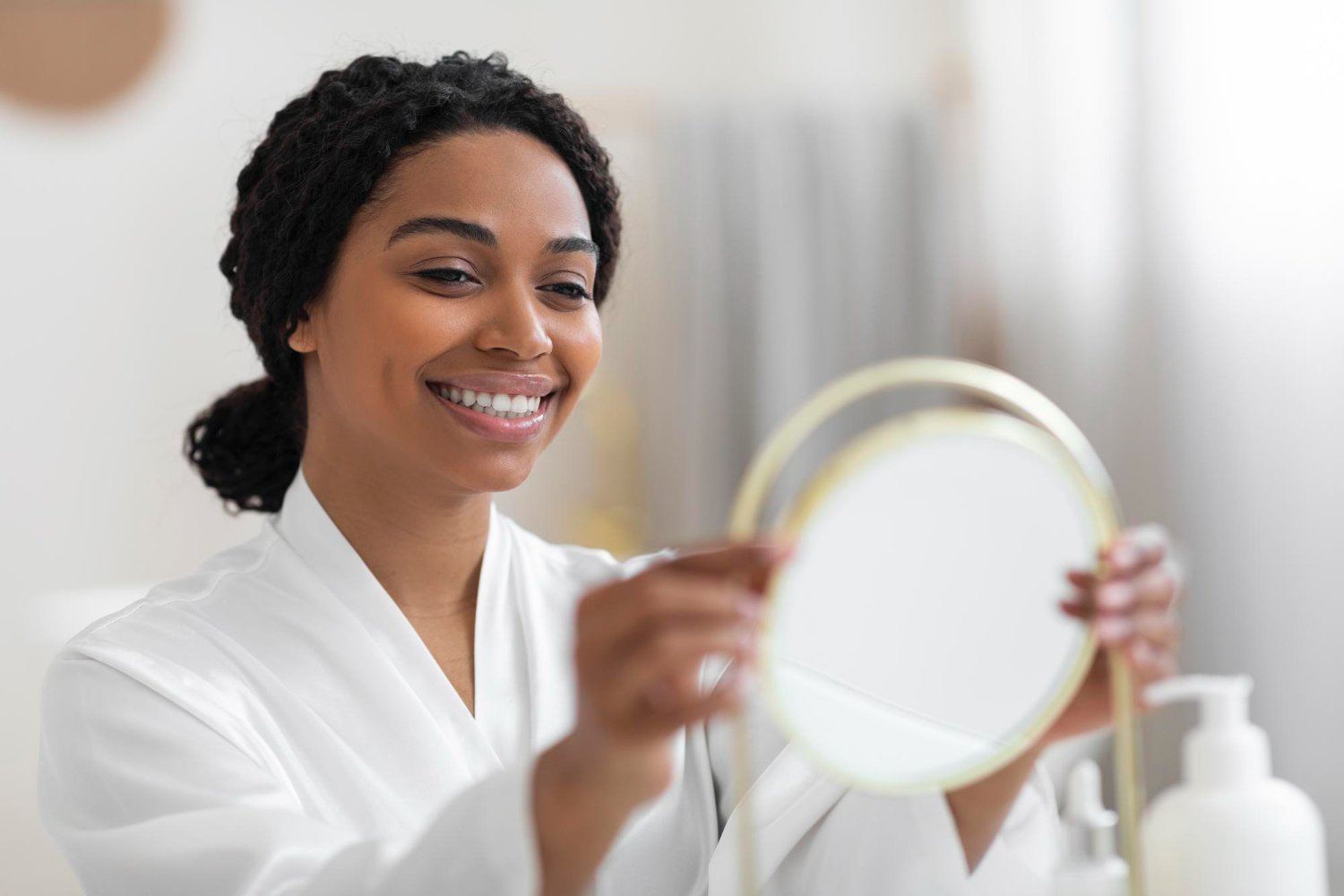 beauty-care-attractive-young-black-woman-looking-magnifying-mirror-home